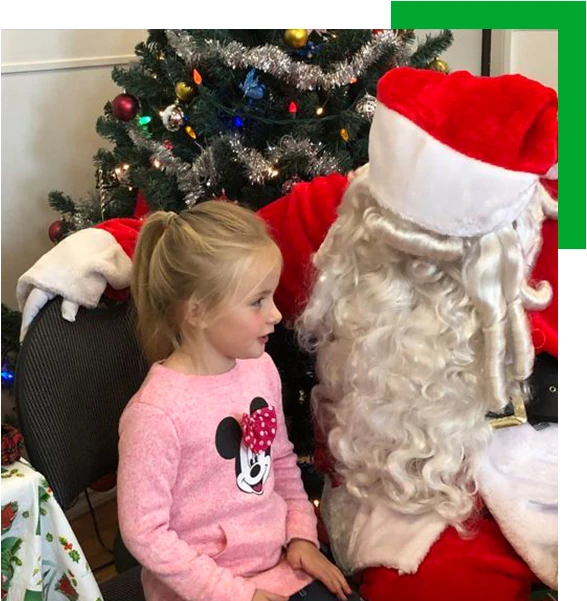 child sitting on santa's lap